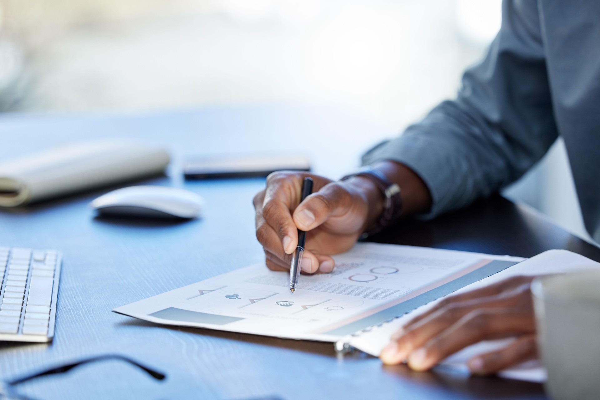 Shot of an unrecognizazble businessman doing paperwork in an office at work